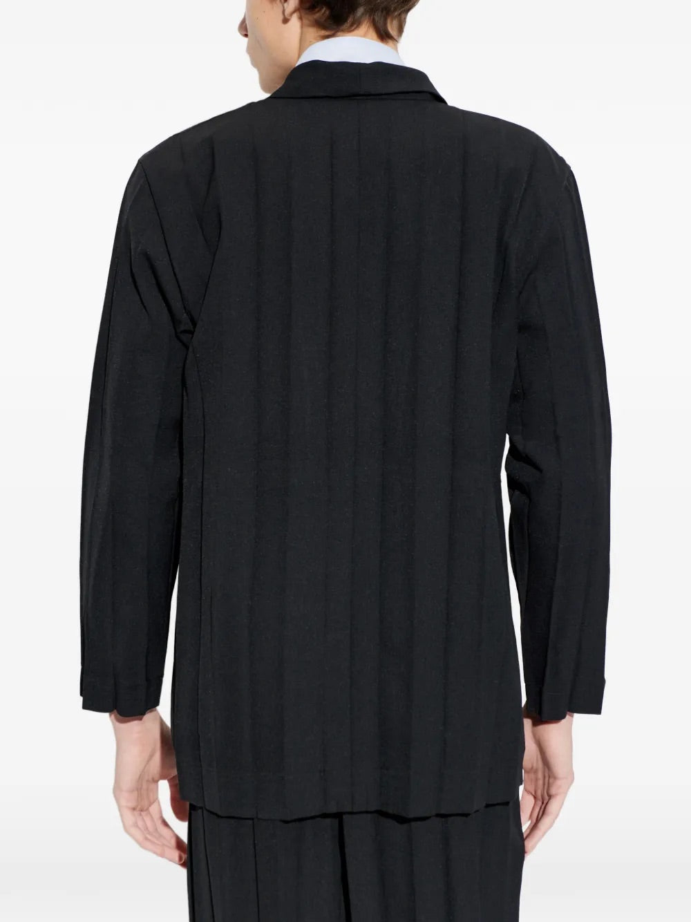 Model wearing Edge Ensemble Jacket in Black by Homme Plissé Issey Miyake, back view of black plissé blazer with straight hem and long sleeves