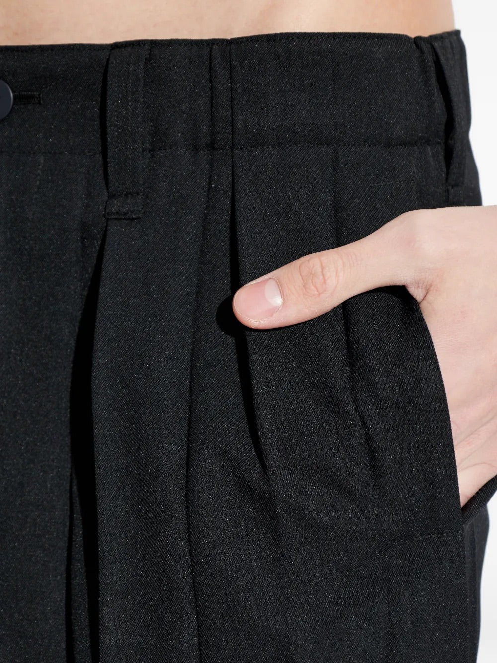 Edge Ensemble Pants in Black by Homme Plissé Issey Miyake, closeup of large plissé pleating texture and side slit pocket detail on black slim-leg trousers