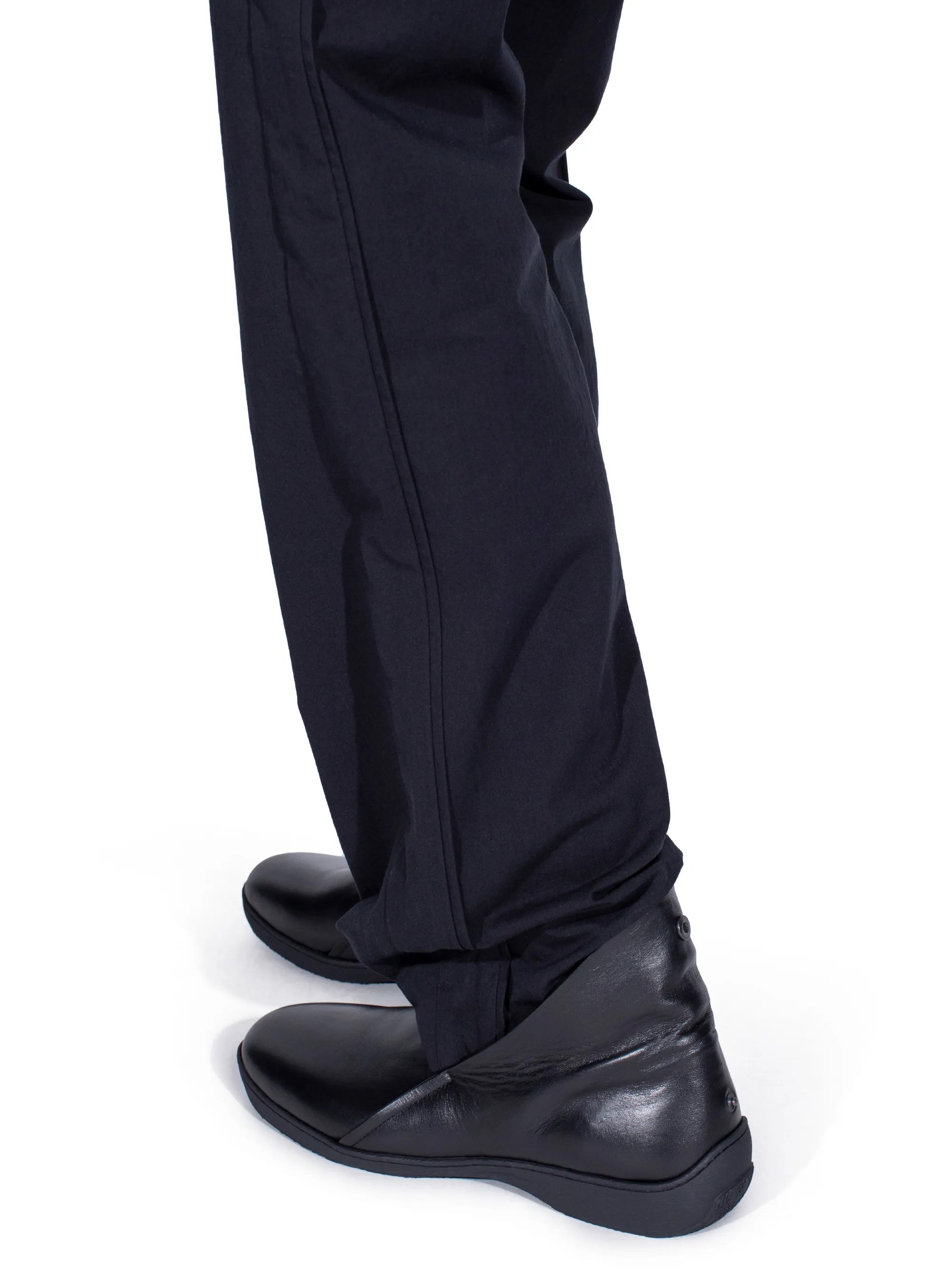Side view of Kiko Kostadinov Iskar Slip-On Shoes in black calf leather showing foldable back, tonal sole and directional rounded shape