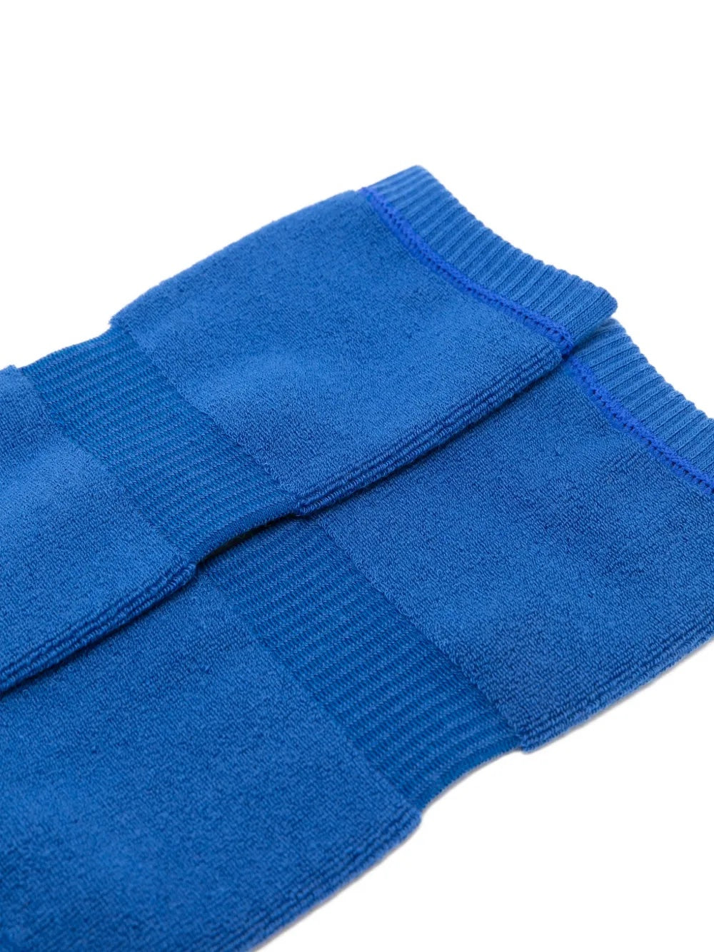 Closeup of Issey Miyake October AW25 Pumped Socks in blue, highlighting ribbed knit texture and elasticated cuff detail.