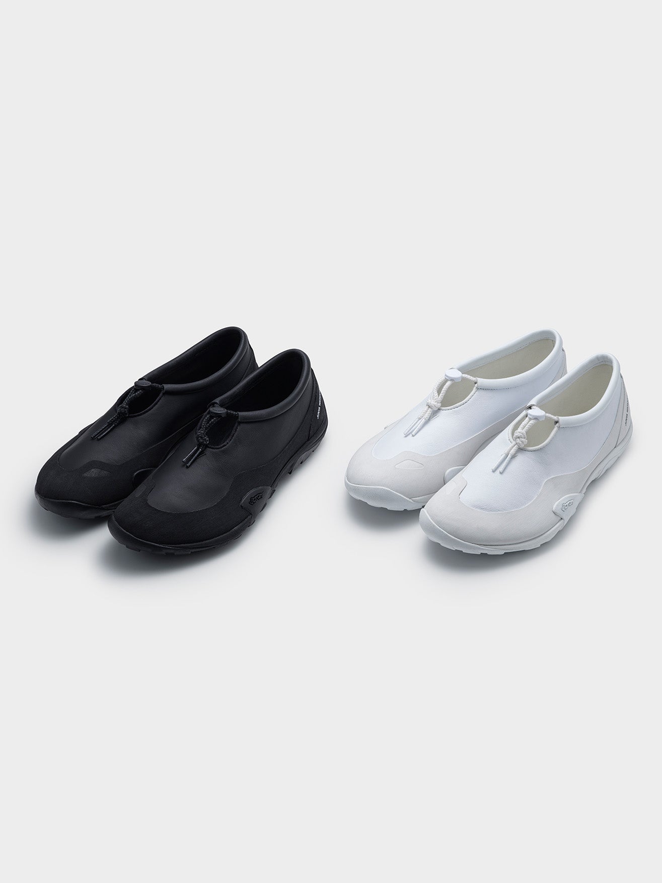 Junya Watanabe x New Balance MT10T sneakers, both colourways, black and white, three-quarter front view