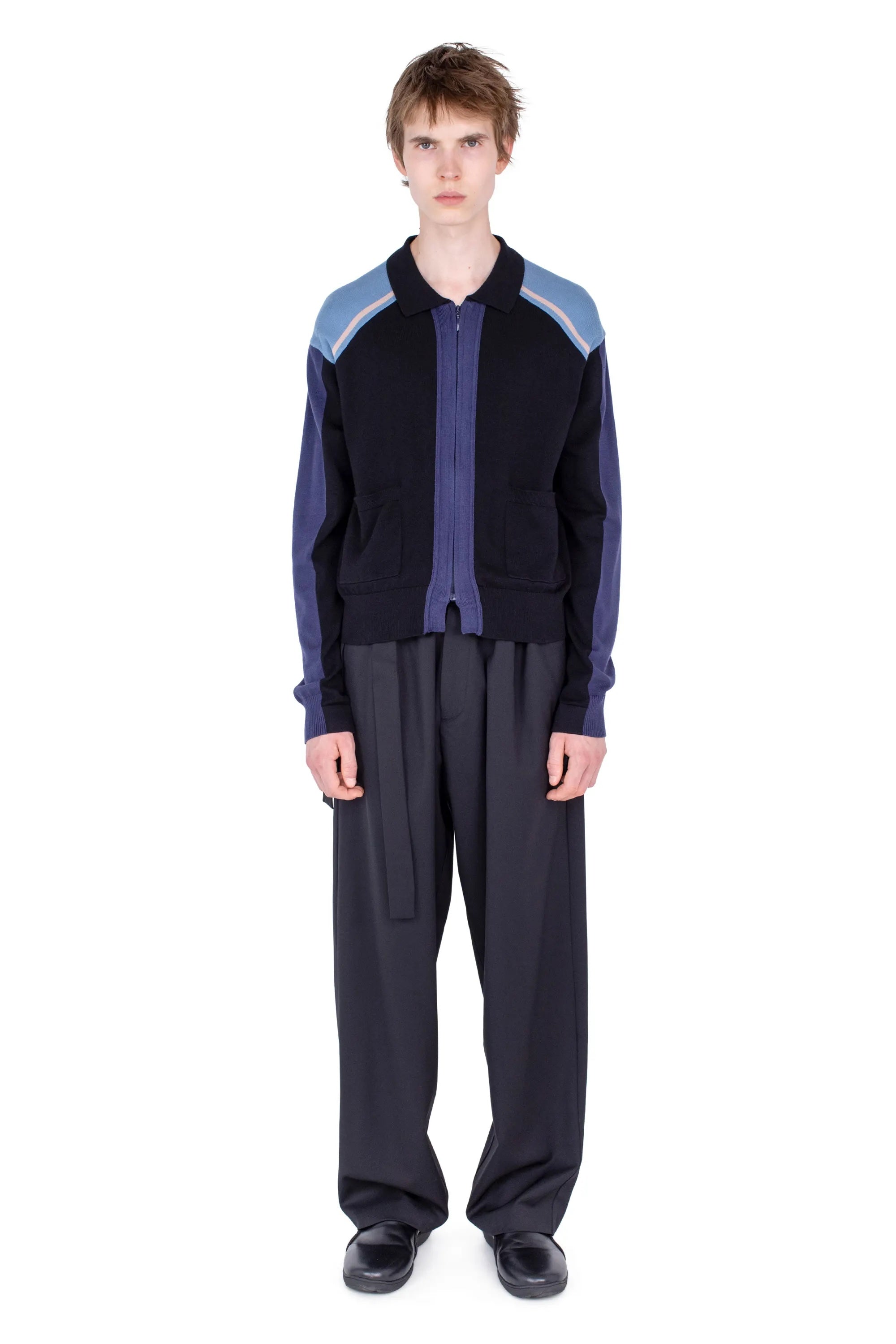 Full front view of Kiko Kostadinov Munno Knit Cardigan in Phantom Black styled with wide-leg trousers and black shoes