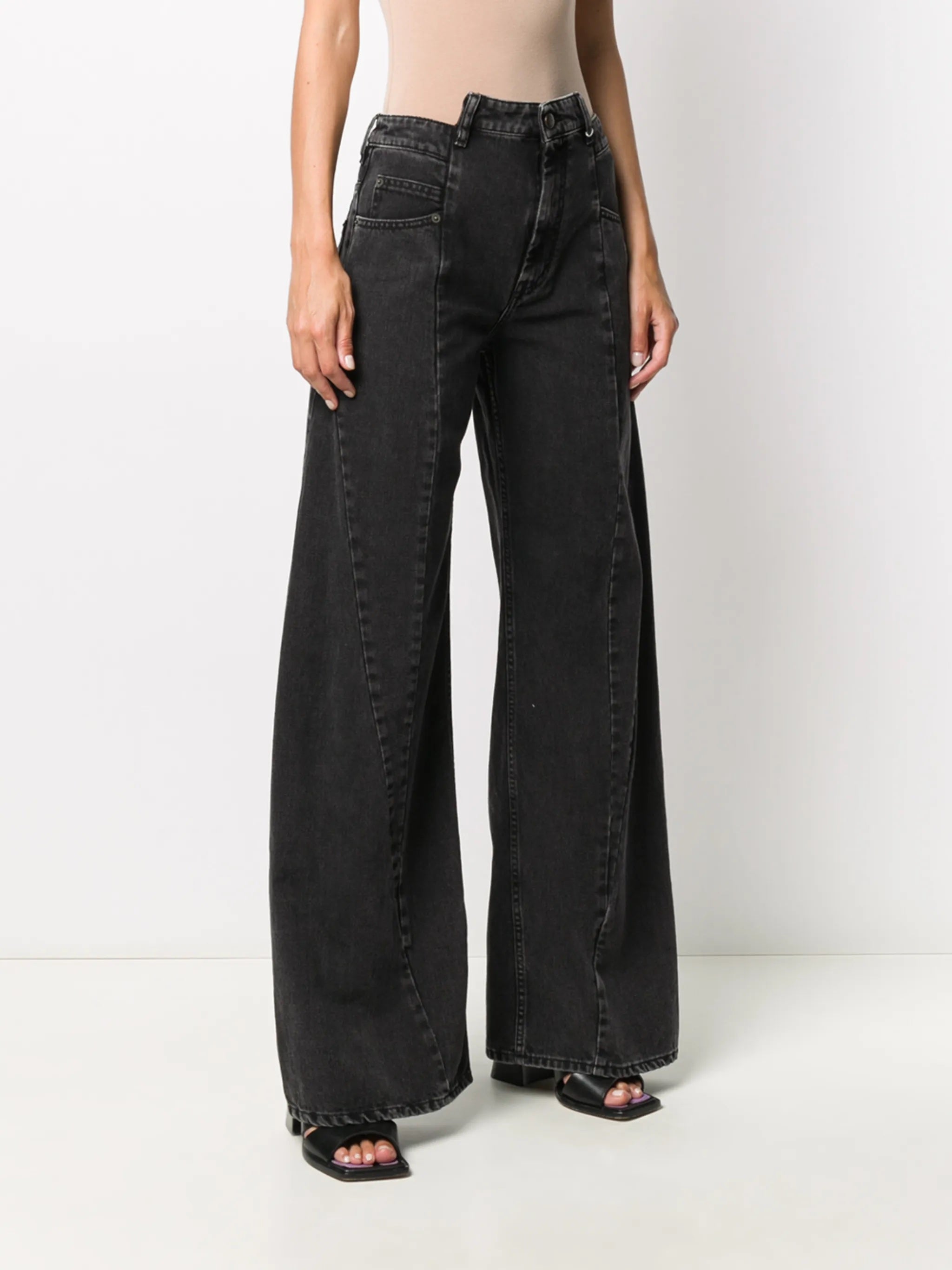 Side view of the model wearing the Medium Black Stone Maison Margiela five-pocket pants, highlighting the wide-leg cut, washed denim texture, and high-rise fit.