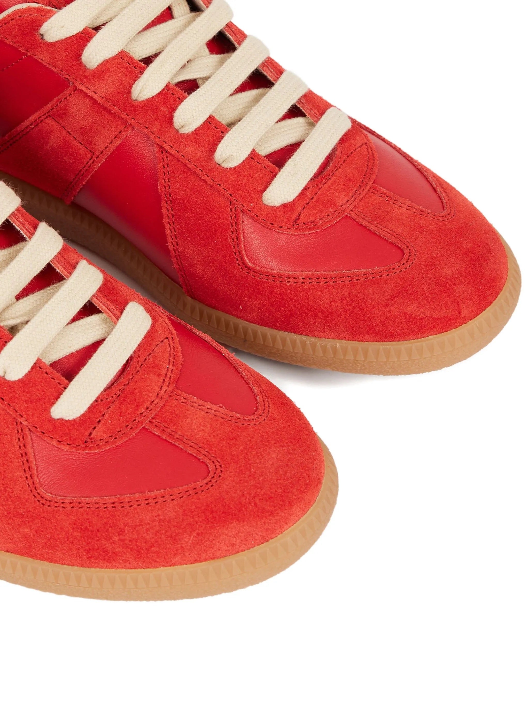 Red sneakers with white laces on a white background
