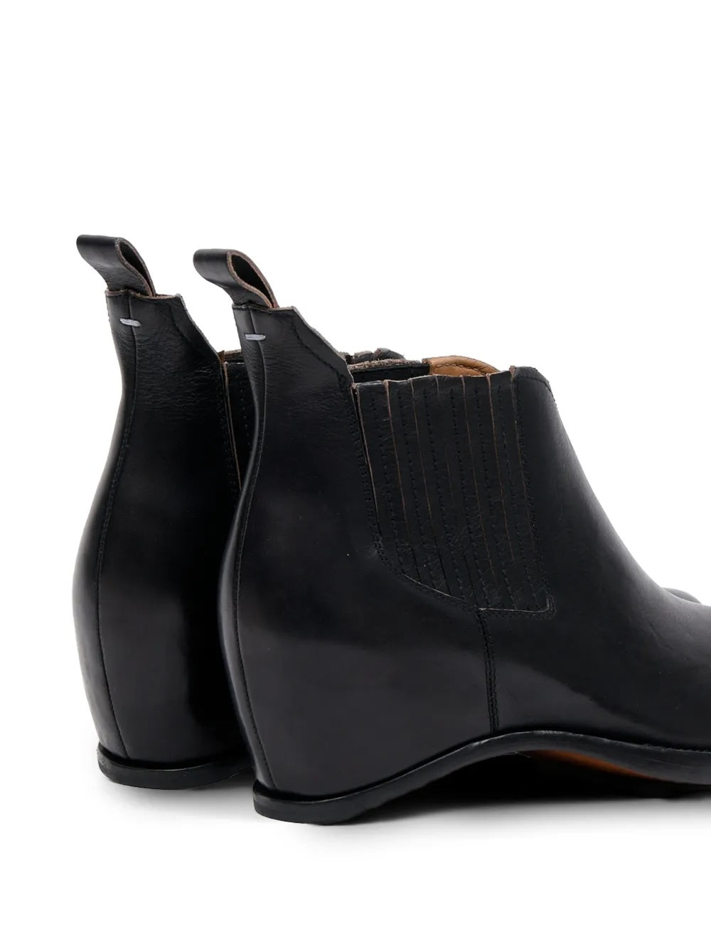 Maison Margiela Heel-Less Western Chelsea Boot 45mm, angled close-up of the heel and elastic gore panel in black leather, with Margiela stitch pin and pull tab detail