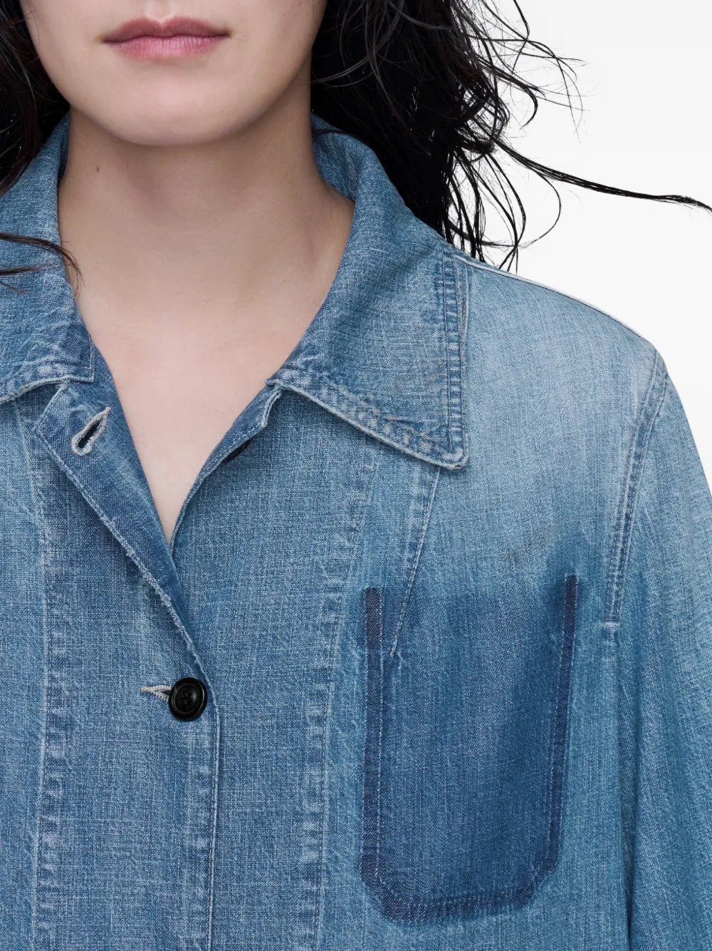 Close-up of the collar area of the Long-Sleeved Shirt in Medium Blue Vintage by Maison Margiela as worn by a model, highlighting the classic collar and blue denim texture.