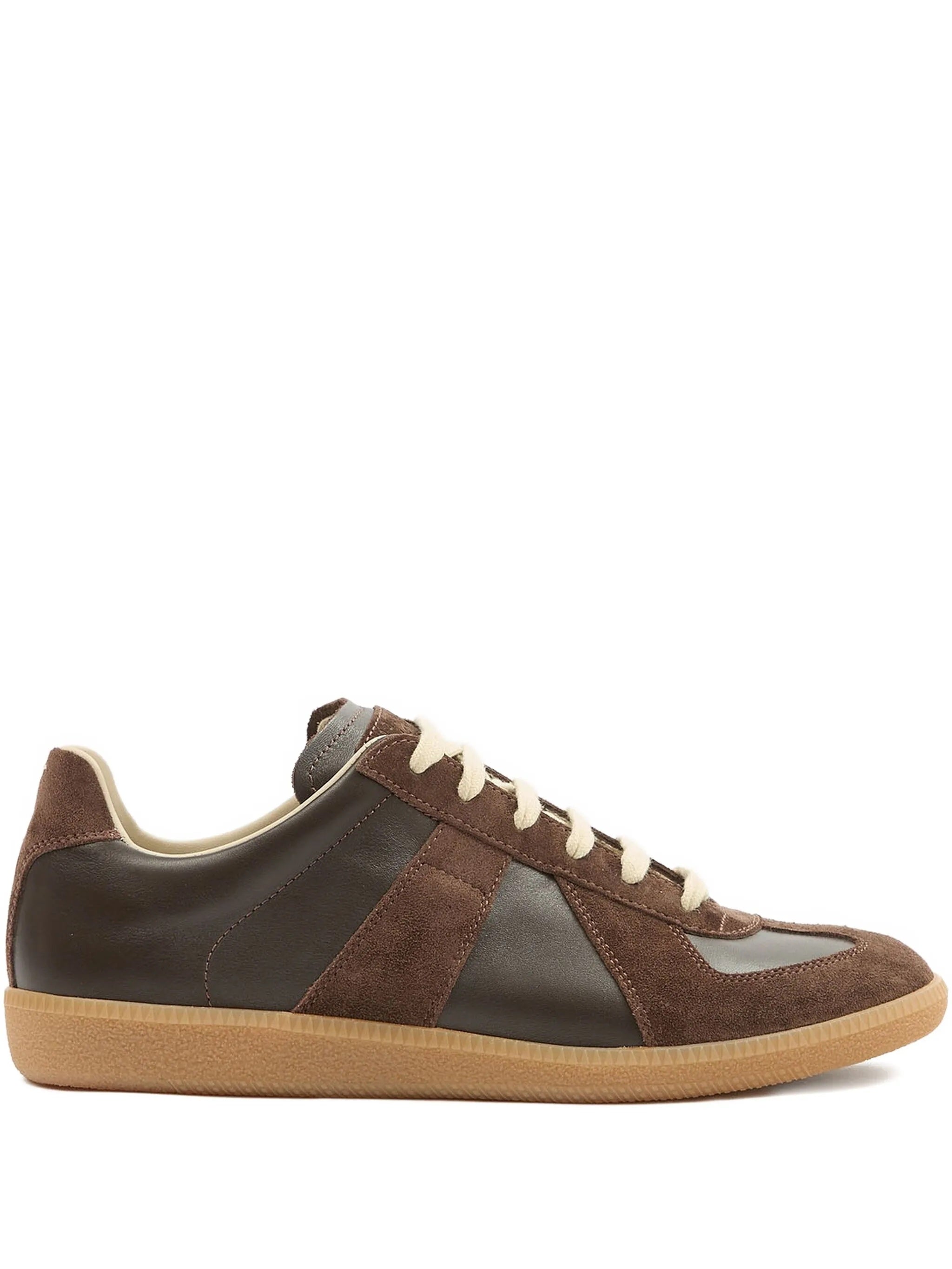Brown and black sneaker with beige sole on a white background