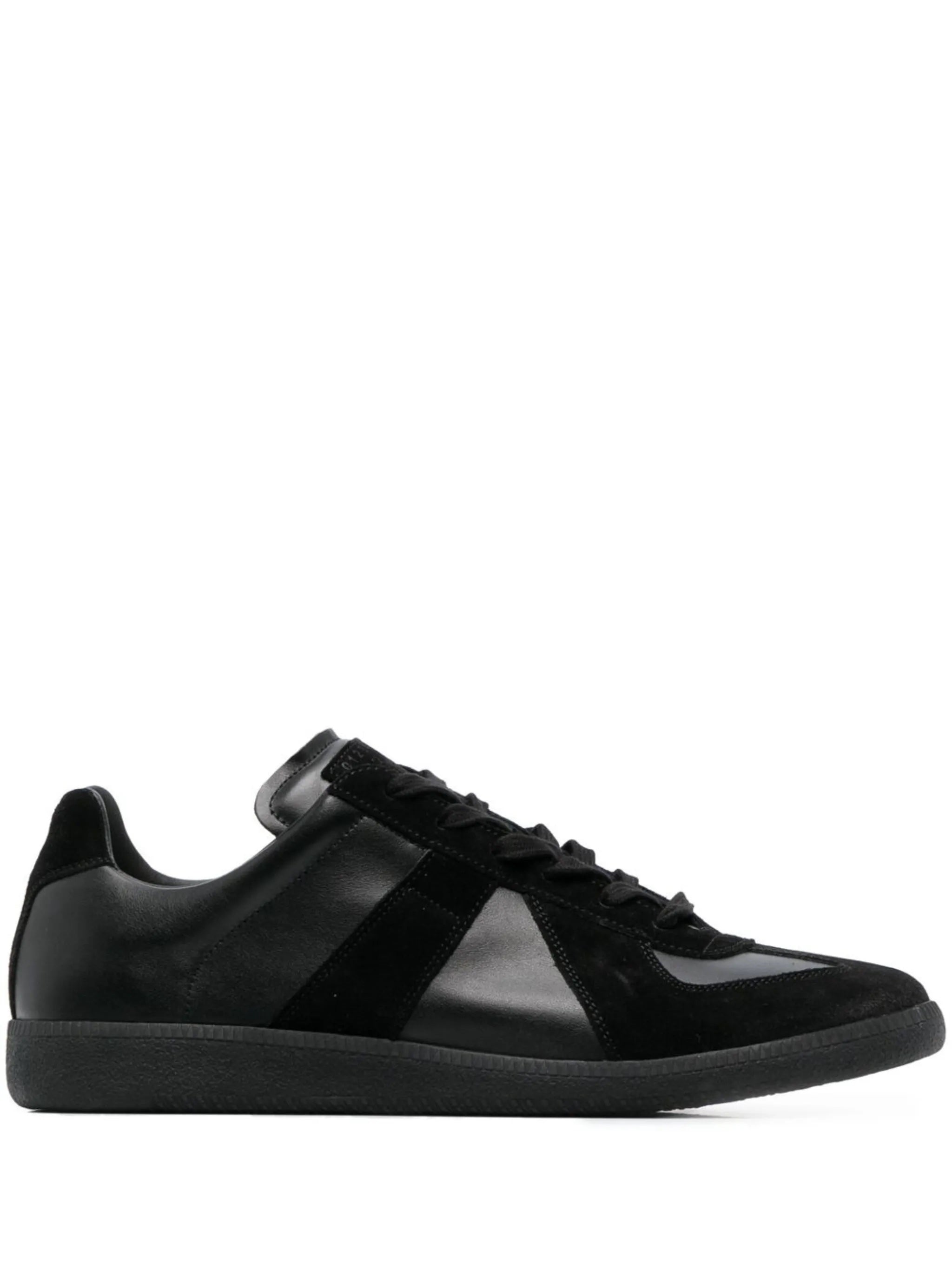 All black leather sneakers with panel design from Maison Margiela on a white background