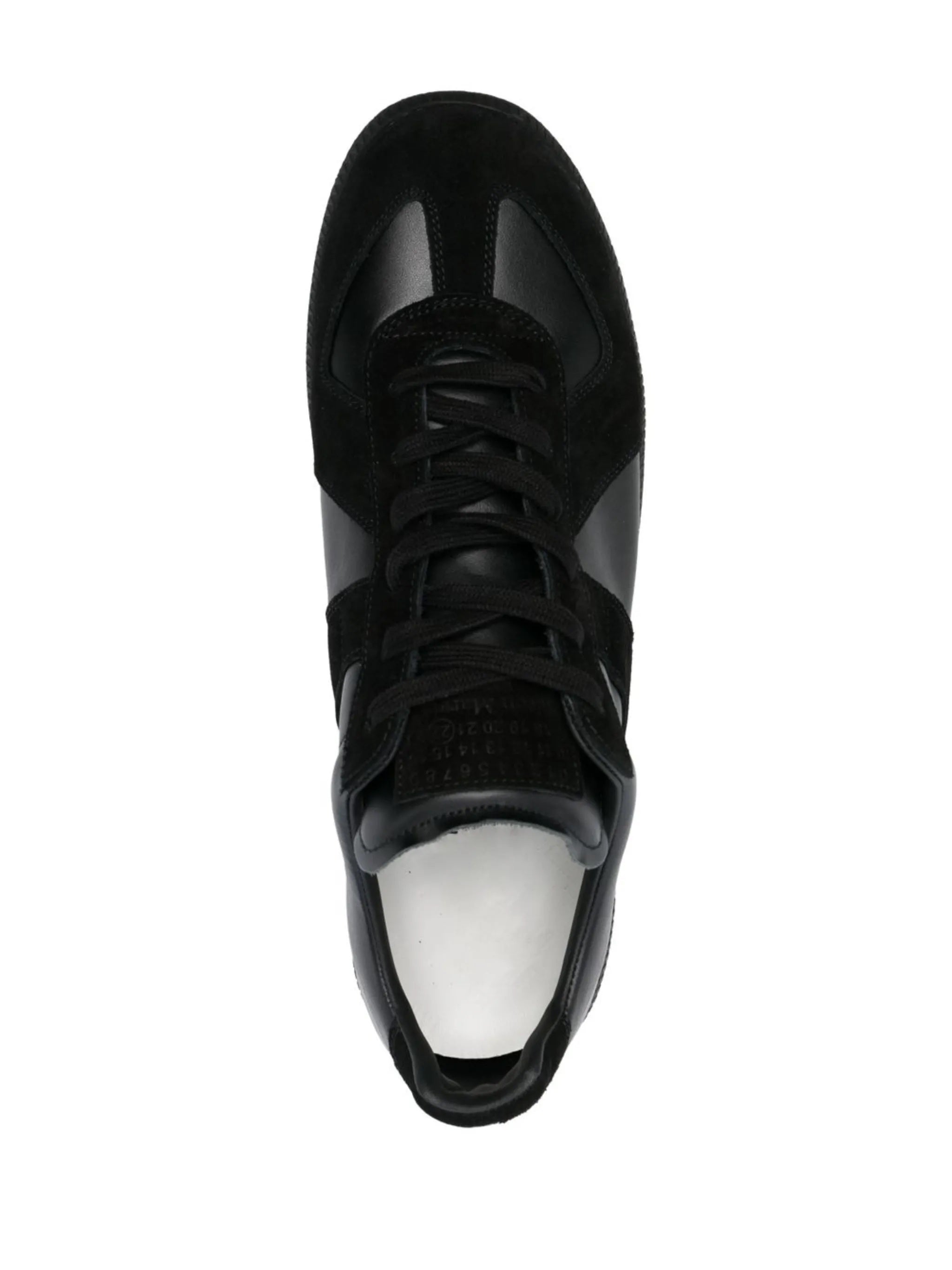 Top view of the all black leather sneakers from Maison Margiela on a white background