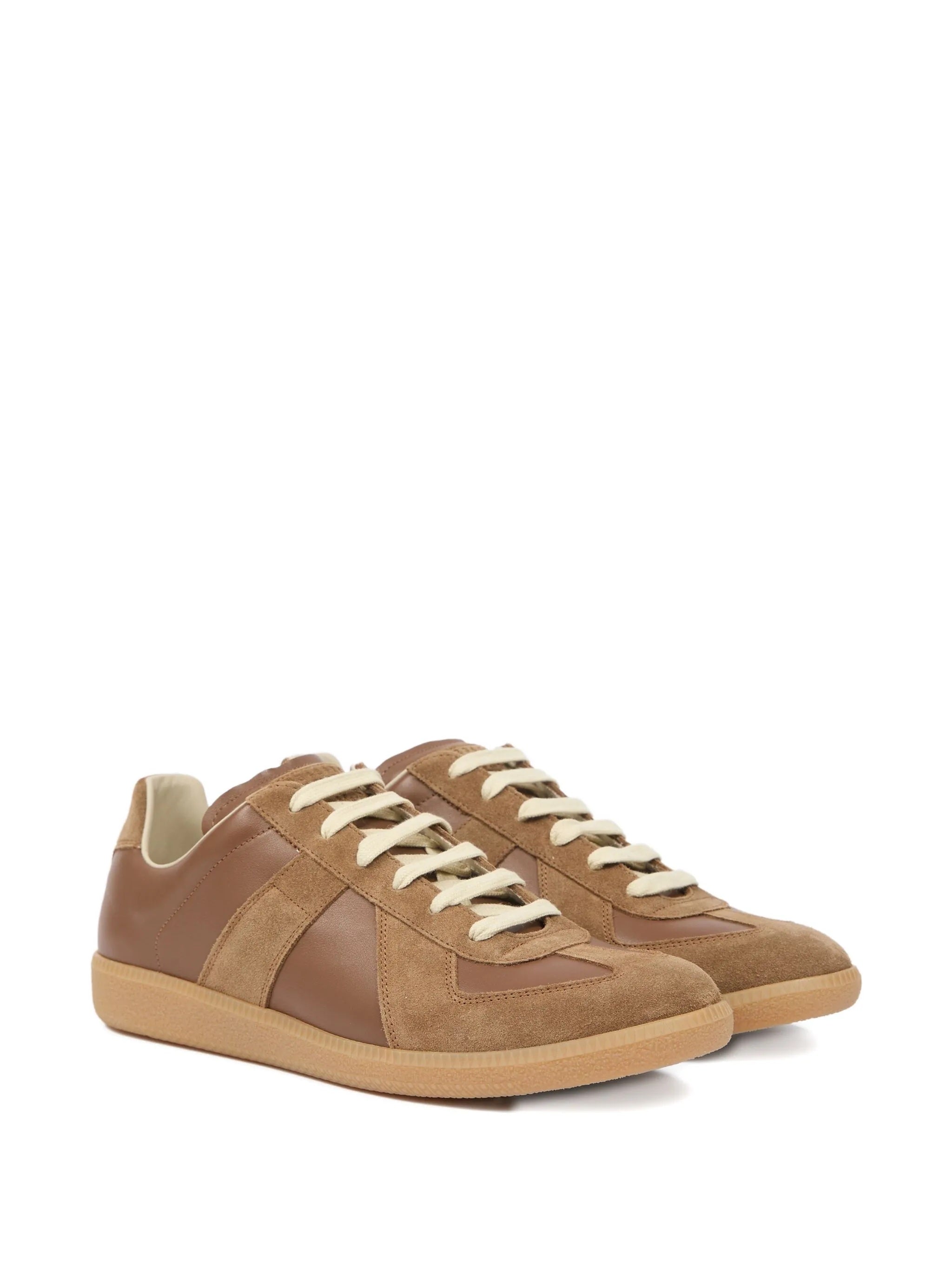 A pair of brown leather sneakers with panel design from Maison Margiela on a white background