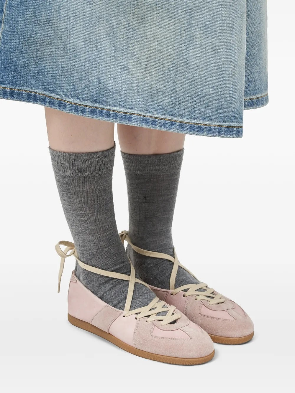 Model wearing the Maison Margiela Replica Soft Laced Ballets in Pale Blush with grey socks