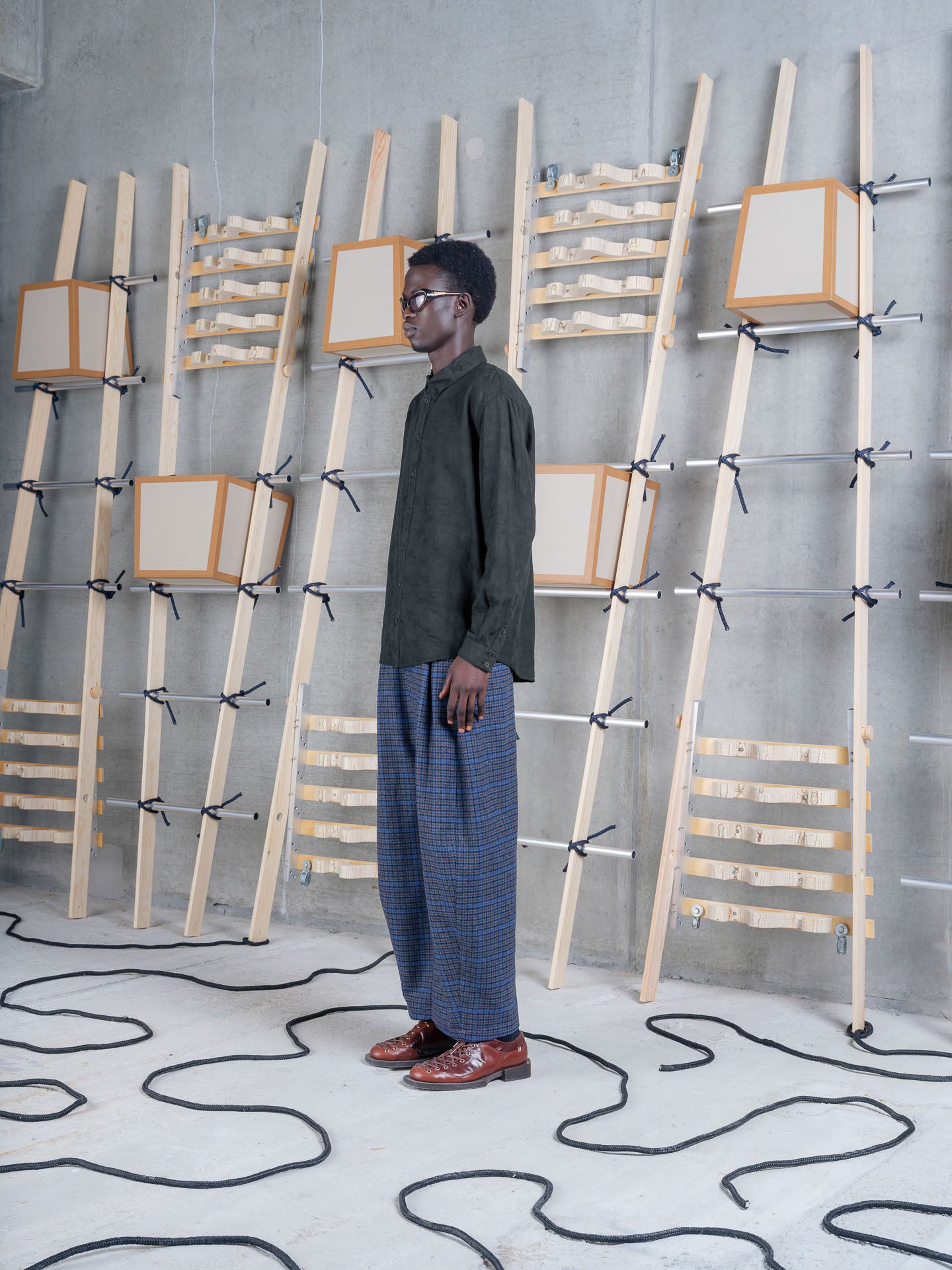 Model wearing Henrik Vibskov One Pants in Blue Wool Checks side view
