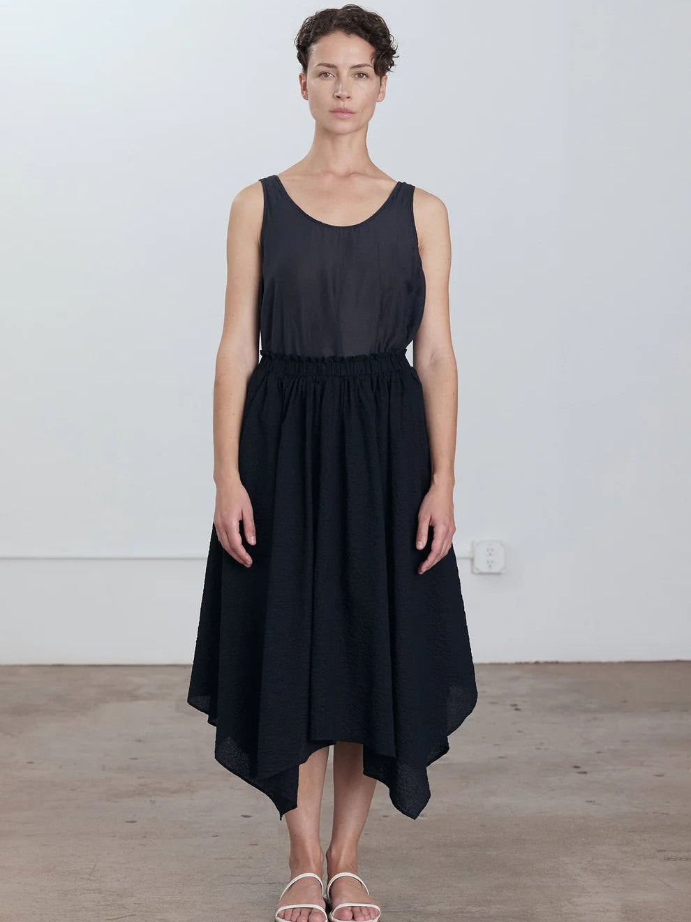 Black Crane Paper Skirt in Midnight - closer front view on model showing elasticised waistband with raw-edge frayed detail