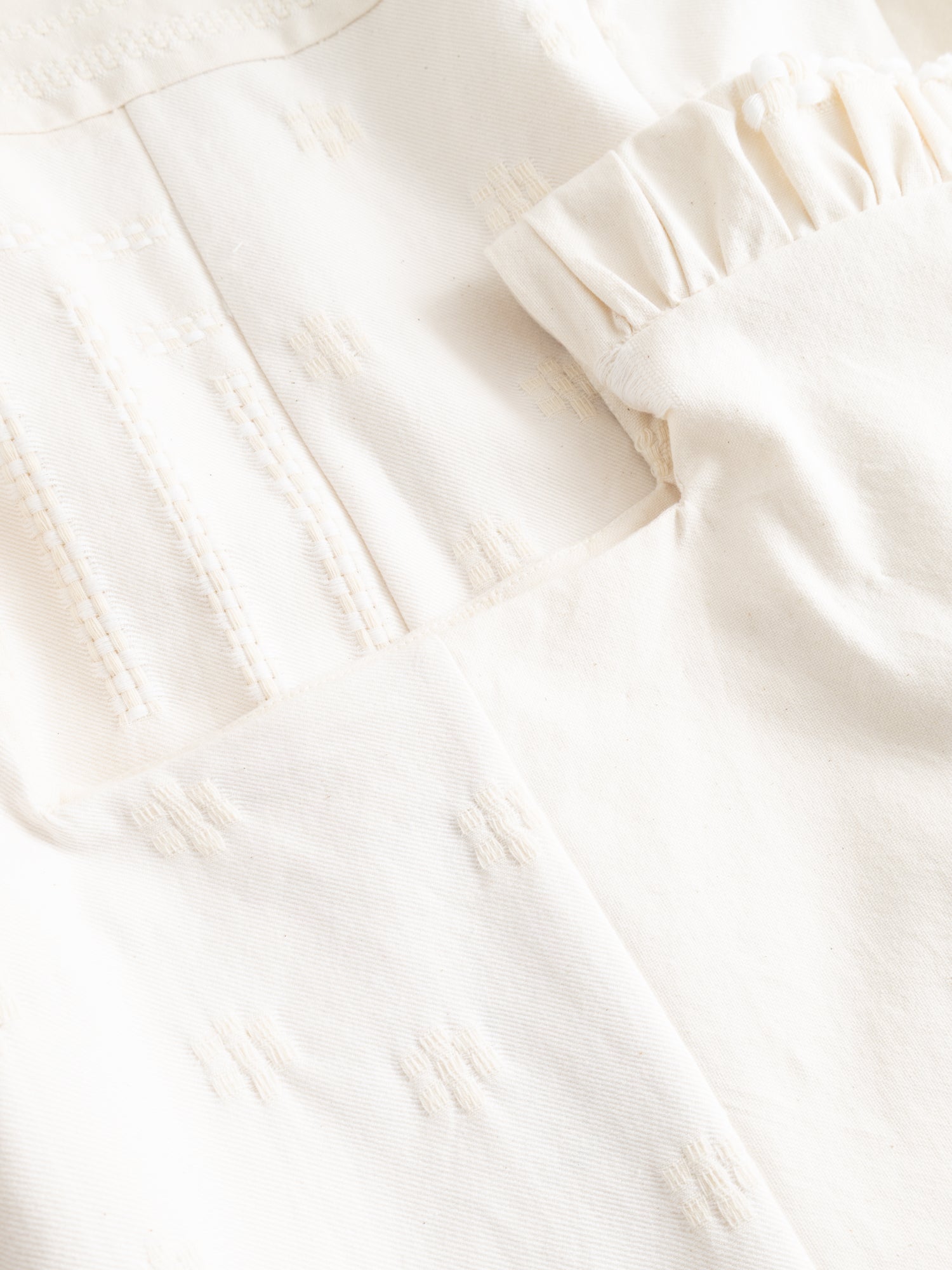 Stem Patchwork Dress in off-white, close-up of patchwork bodice construction with woven Tencel thread detail and gathered shoulder