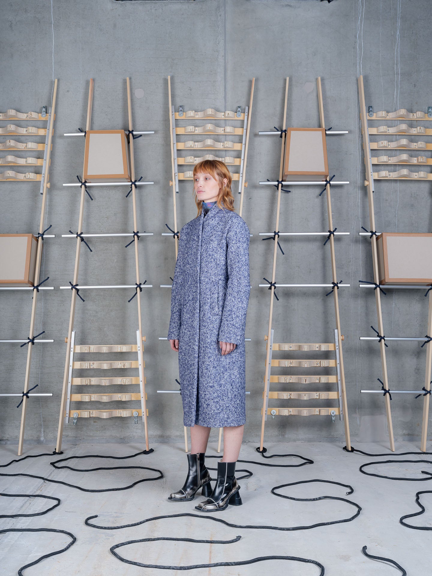 Model wearing Henrik Vibskov Shell Coat in Blue Pebbles front three-quarter view
