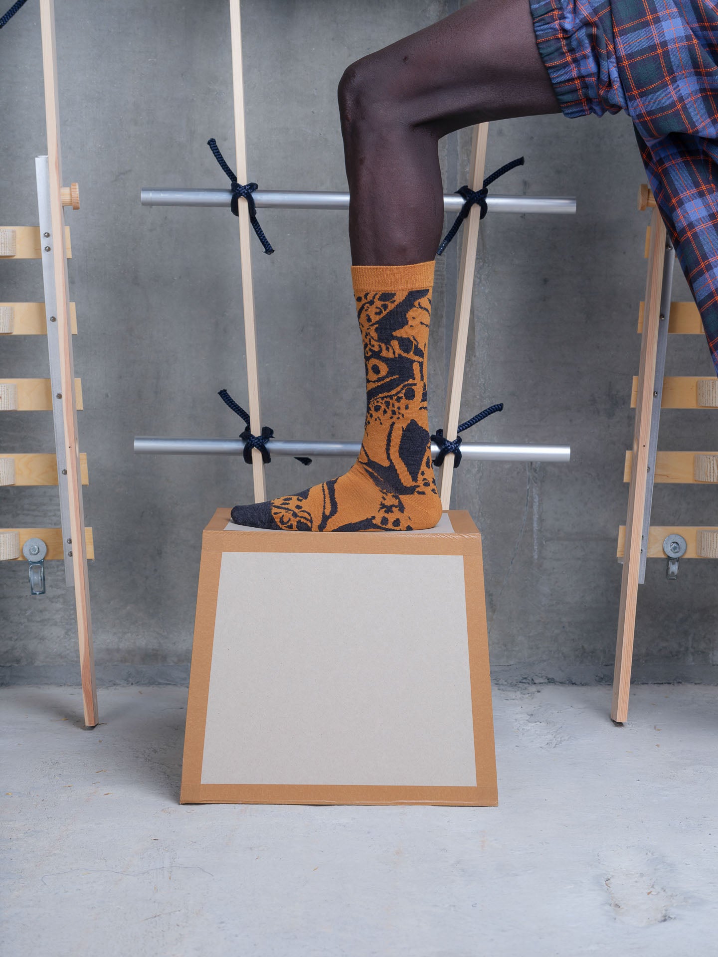 Model wearing Swamp Sock in Spice Mess Frog by Henrik Vibskov