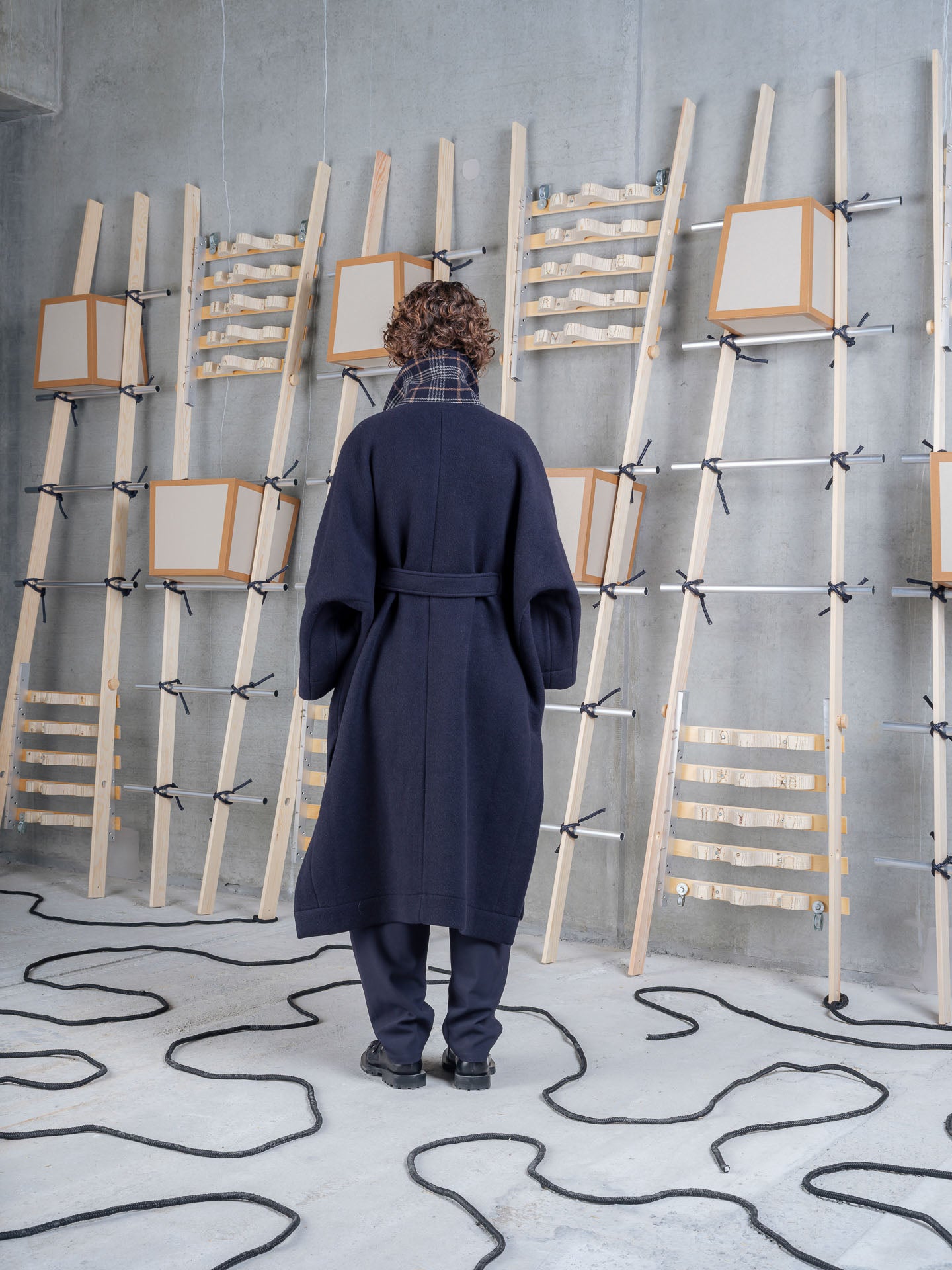 Model wearing Henrik Vibskov Toadcoat in Navy Duffle back view