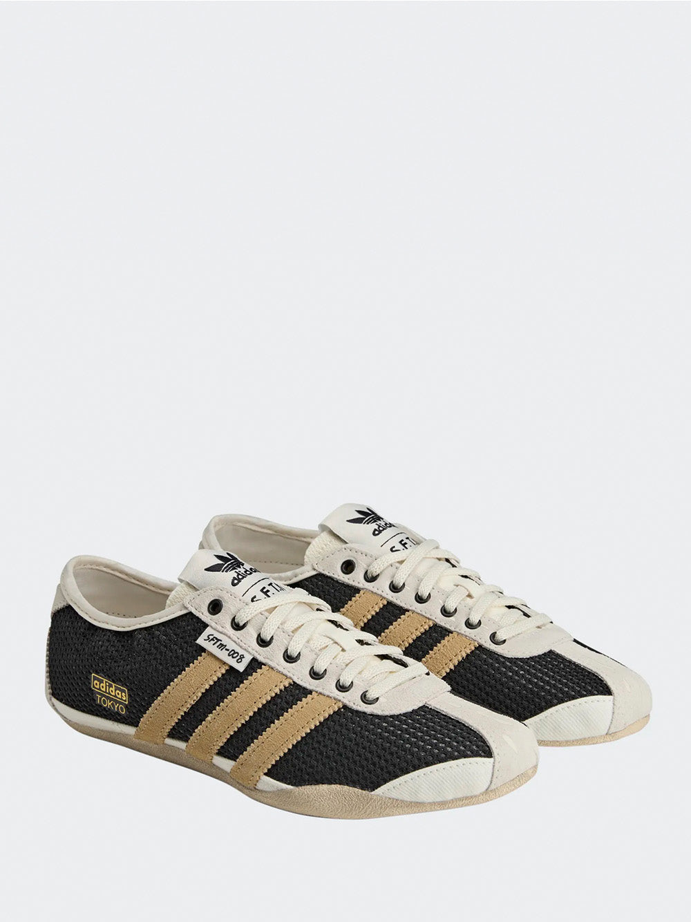 Adidas Tokyo W SFTM in Black/Beige/Gold - three-quarter view showing black textured upper with gold three stripes