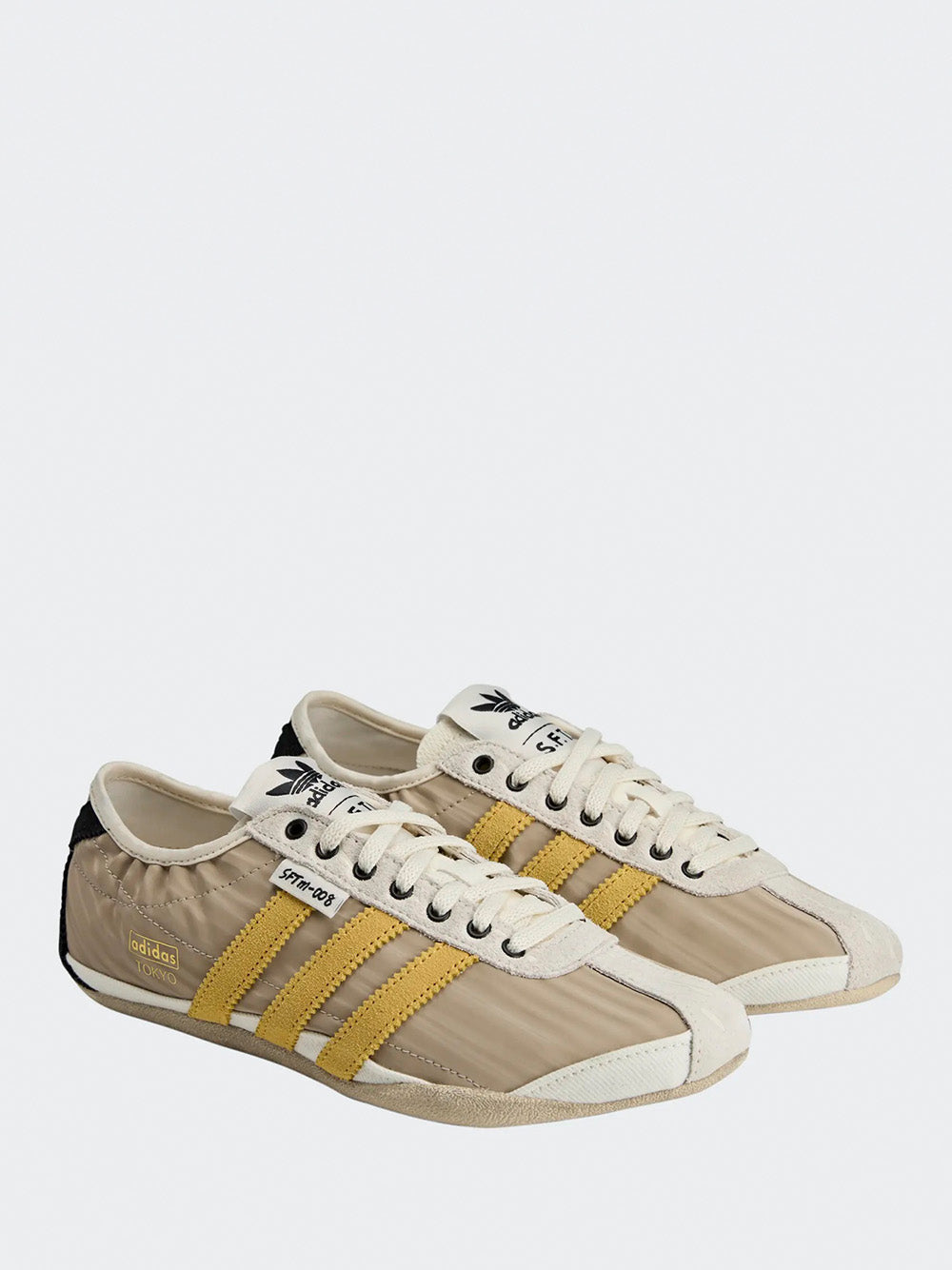 Adidas Tokyo W SFTM in Off White/Yellow/Black - three-quarter view showing off white upper with yellow three stripes detailing