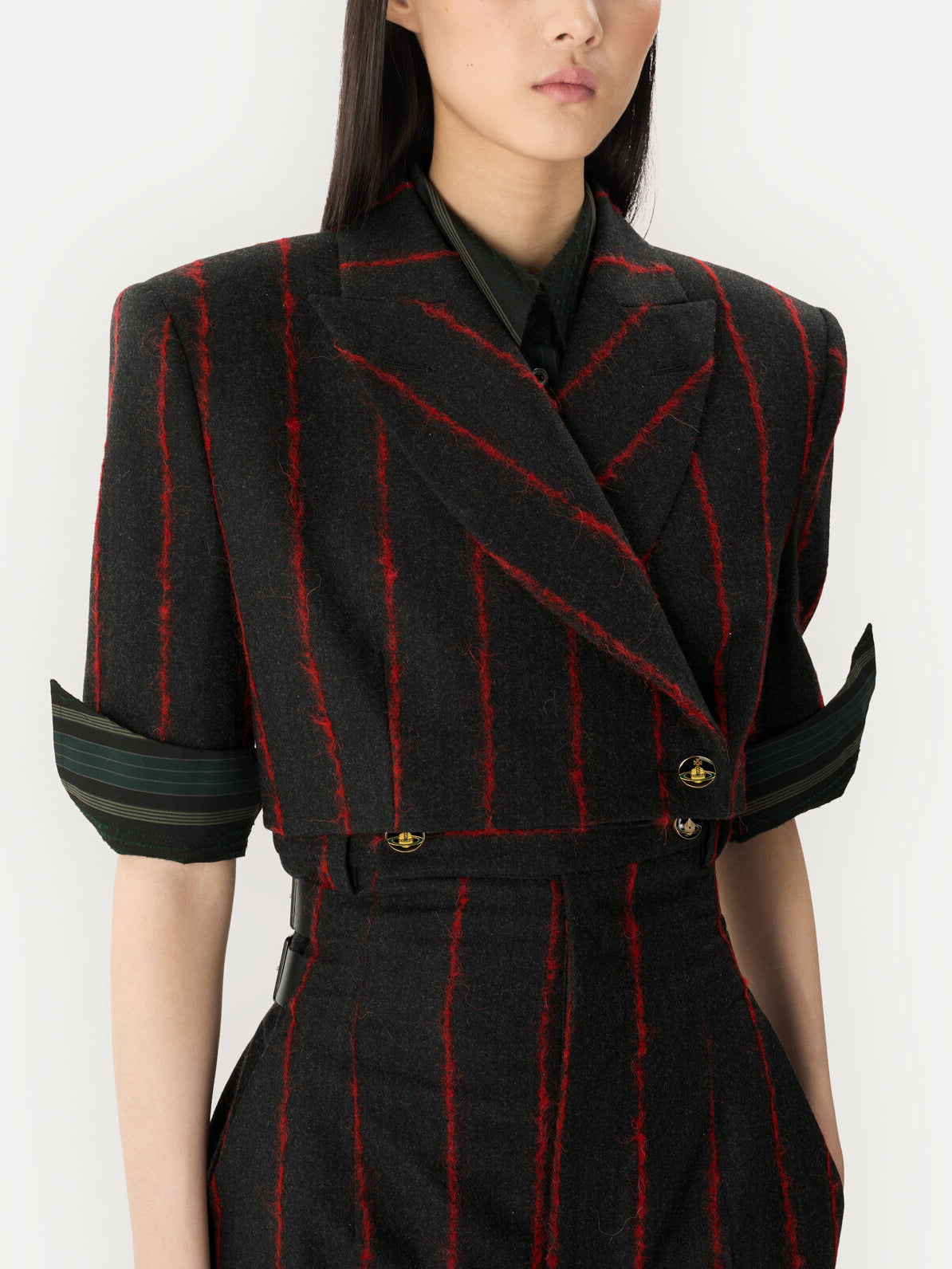 Close-up of Vivienne Westwood Cut Off One Button Jacket showing peaked lapels, red striped wool-blend fabric and single-button fastening