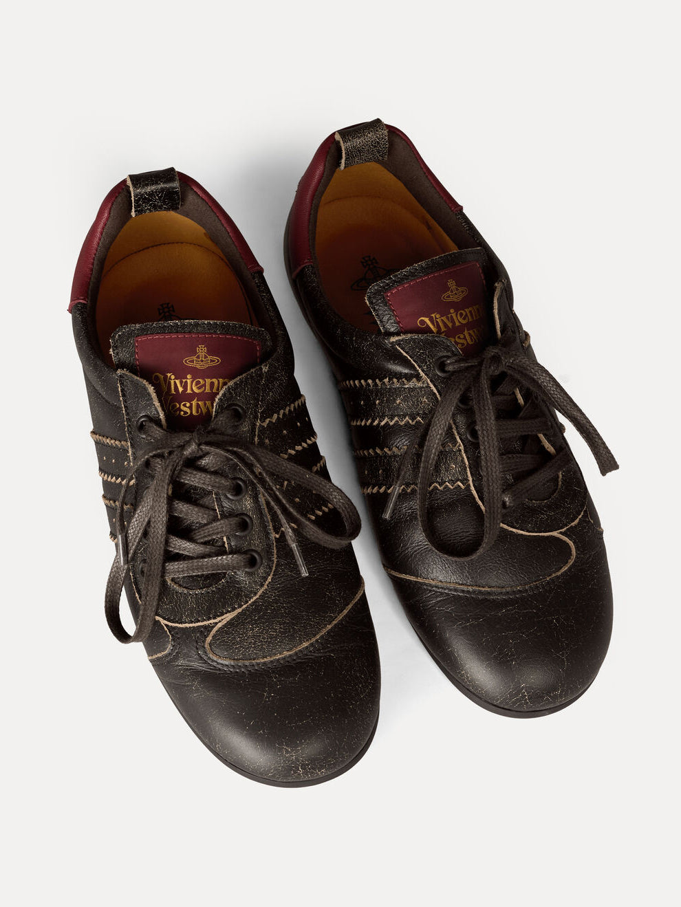 Close-up top view of Vivienne Westwood Drunken Trainers in Off Black showing branded footbed, padded leather and lace fastening