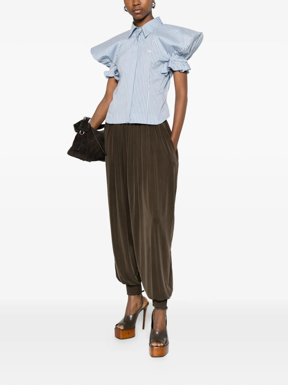 Model wearing Gexy Top in Blue/White by Vivienne Westwood, full-length front view of blue and white striped top with pointed collar, gathered sculptural short sleeves and tonal embroidered logo at chest, Spring/Summer 2026
