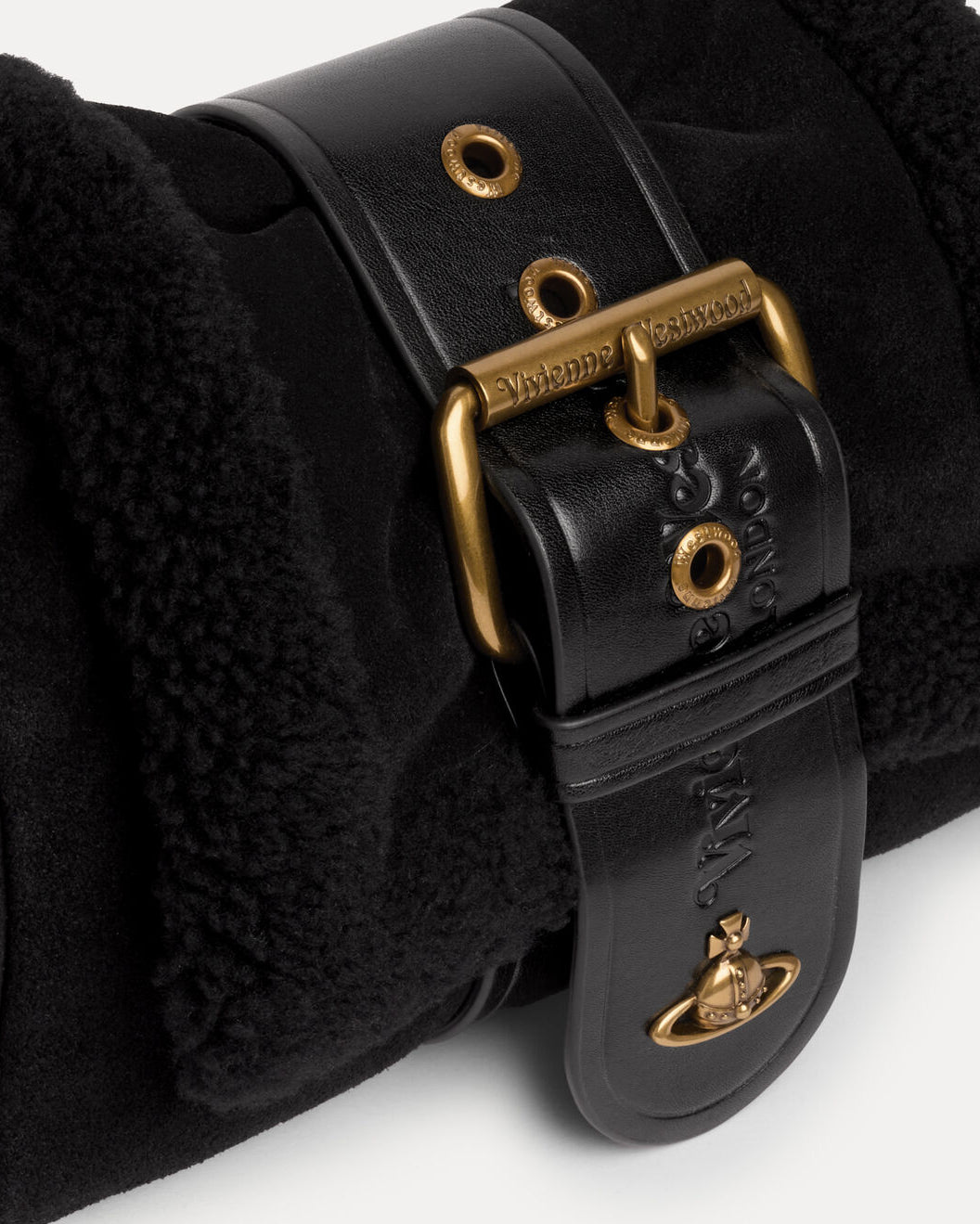 Close-up of Vivienne Westwood Hazel Treasure Handbag in Black showing the buckle strap, gold-tone hardware and front orb plaque.
