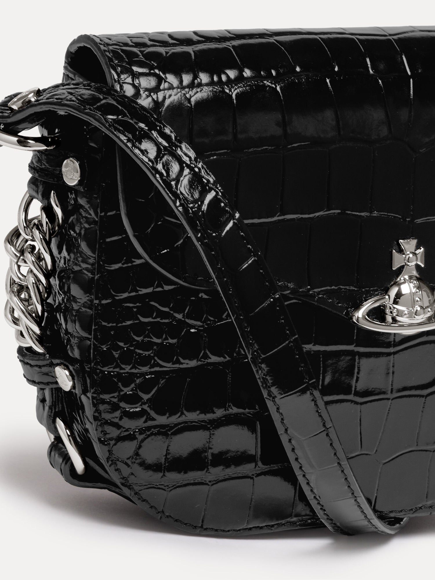 Close-up of Vivienne Westwood Hunter Flap Crossbody in black embossed leather with silver-tone orb fastening and polished chain hardware