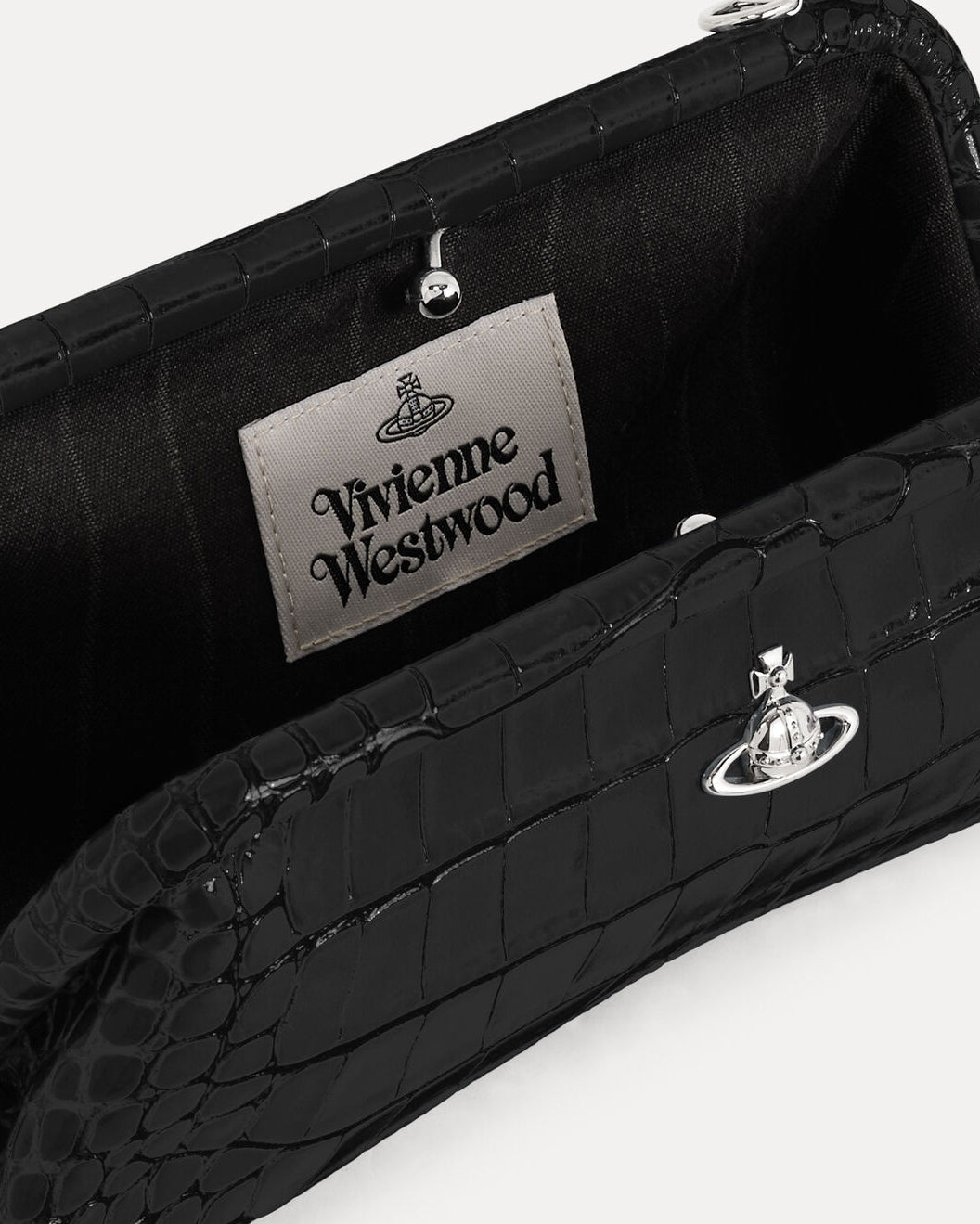 Close-up of Vivienne Westwood Jane Frame Purse in Black showing the interior, brand label and silver-tone orb hardware.