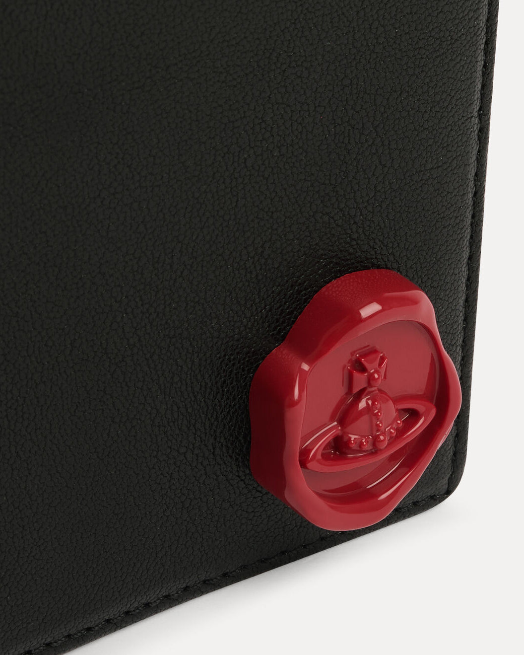 Close-up of the Vivienne Westwood Man Billfold wallet in Black showing the red wax-seal orb detail on the front.