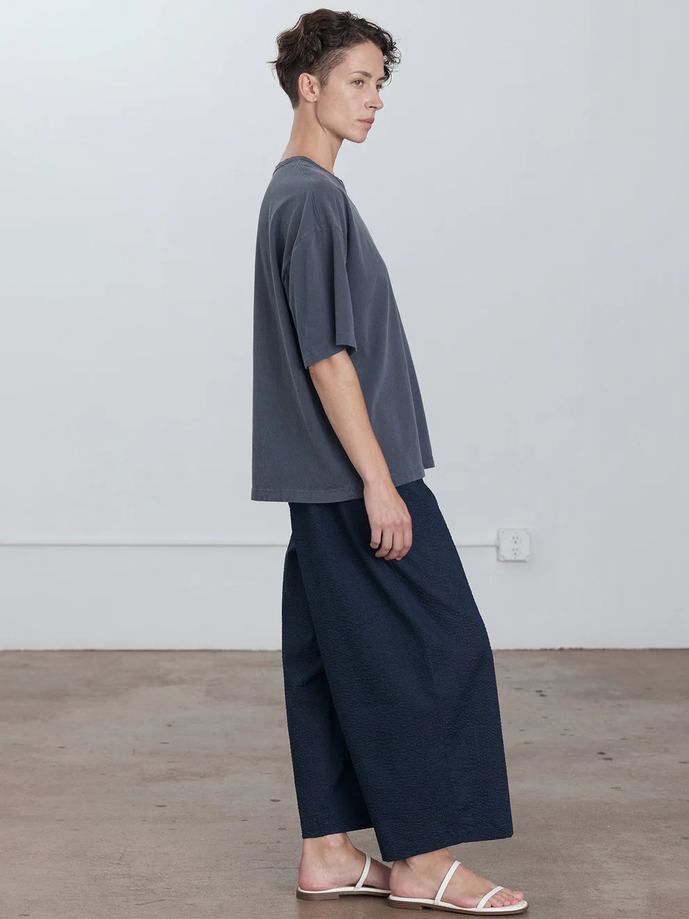 Black Crane Wide Short Sleeve Tee in Indigo - side view on model showing oversized fit and dropped shoulder