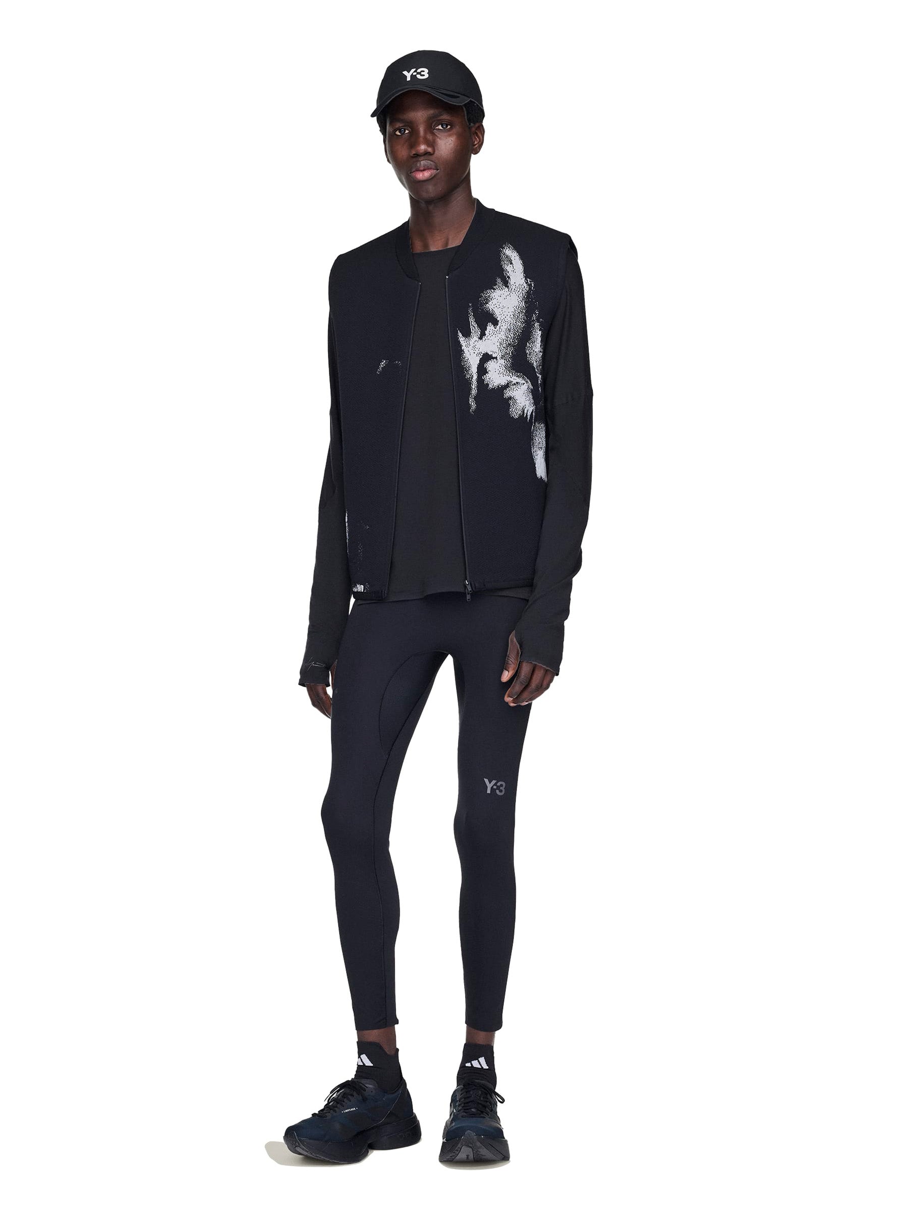 Person wearing a black outfit with white patterns on a white background