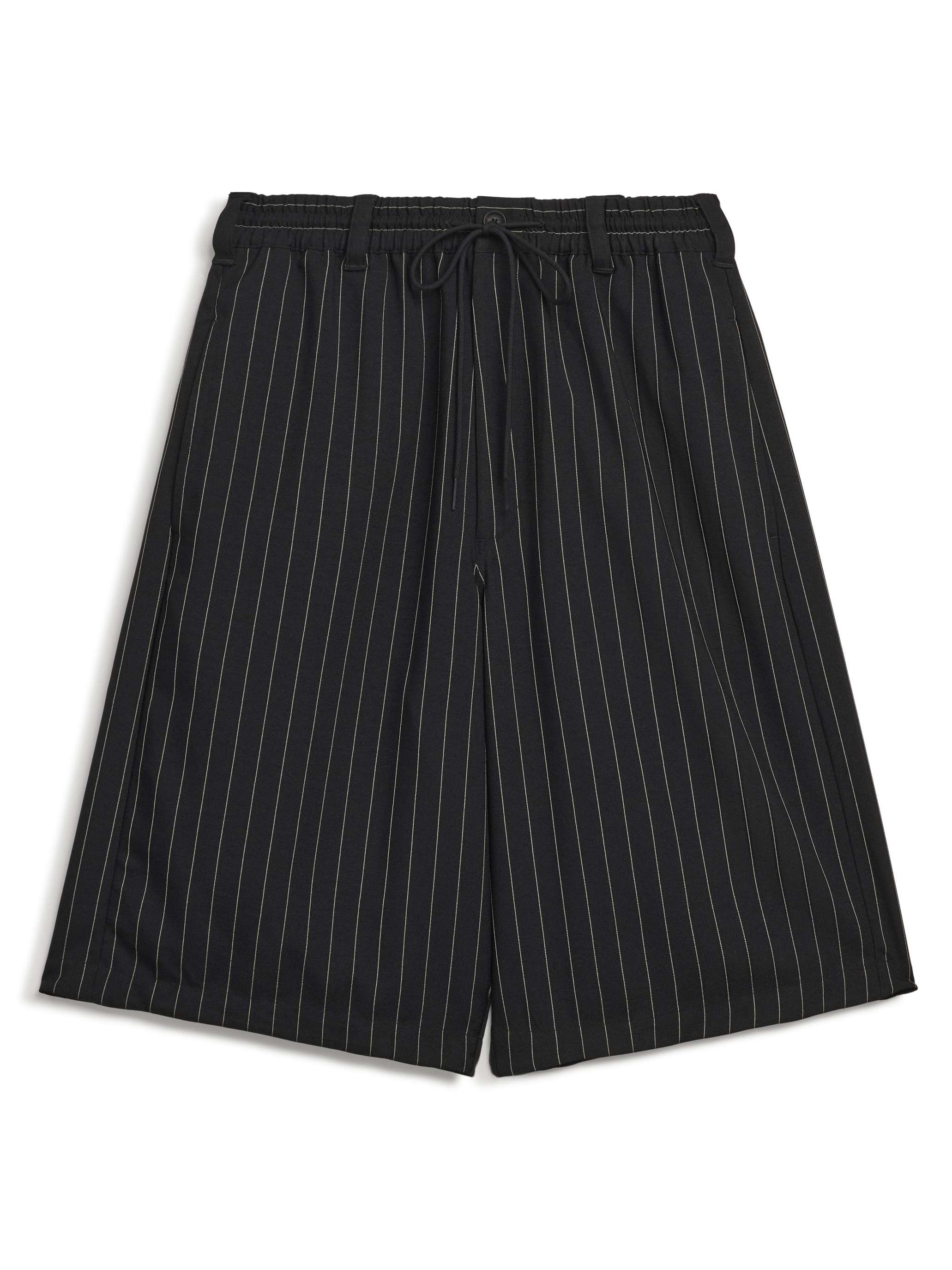 Front packshot of the Y-3 Pinstripe Sport Uniform Shorts in Black, showing the pinstripe design, oversized silhouette, and woven construction.
