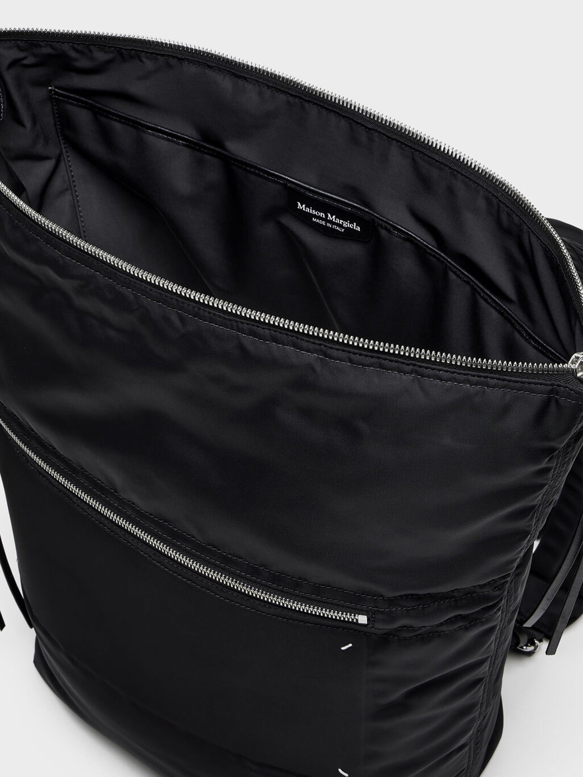 Maison Margiela Zip Line Backpack in Black close-up of wide zip opening